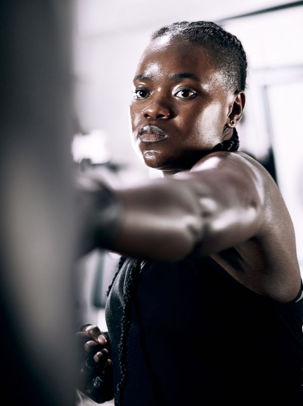 Cropped shot of an attractive young female athlete working out on a boxing bag in the gym.